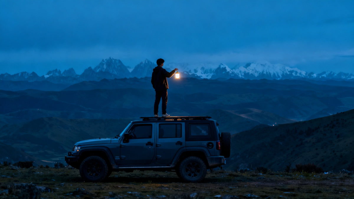 Traveler holding lantern on SUV roof at blue hour